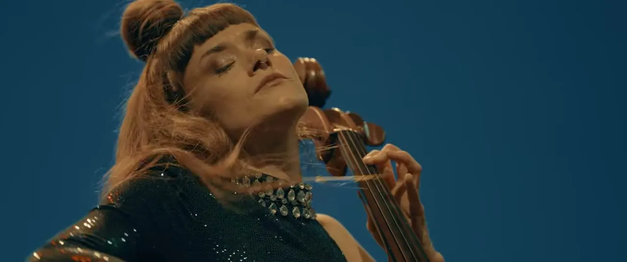 Evening performance at the 2026 Oslo Freedom Forum, cellist under stage light